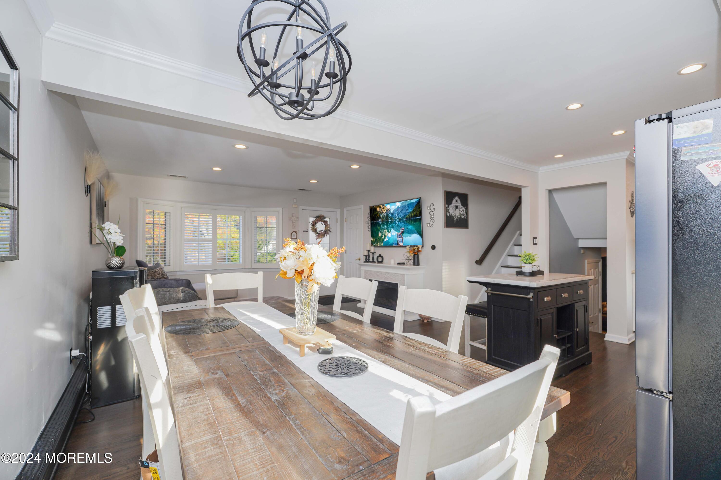 13 Bartle Road Somerset, NJ 08873 - Photo 10 of 26 a living room with furniture a wooden floor and a chandelier