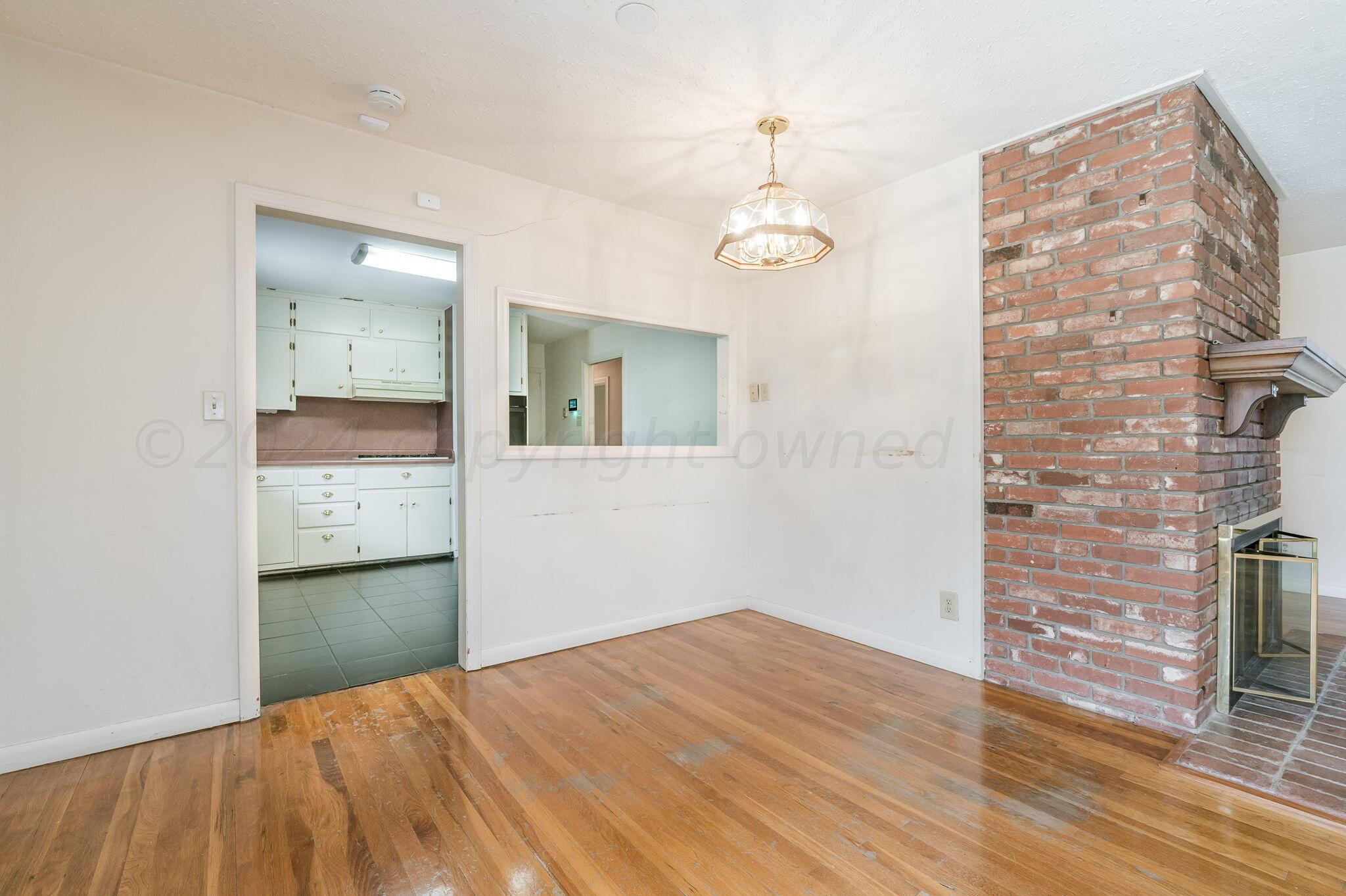 3415 Paramount Boulevard Amarillo, TX 79109 - Photo 11 of 44 wooden floor in an empty room with a mirror