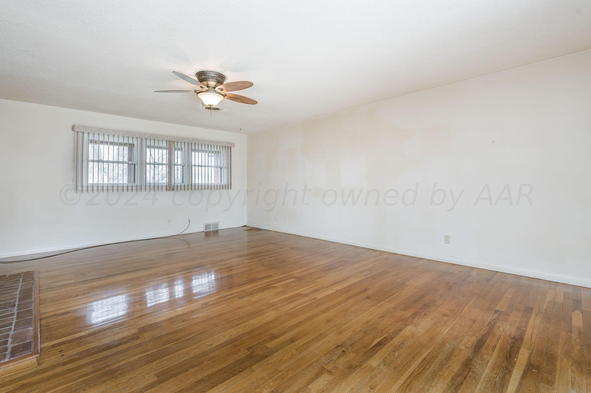 3415 Paramount Boulevard Amarillo, TX 79109 - Photo 13 of 44 a view of empty room with wooden floor and fan