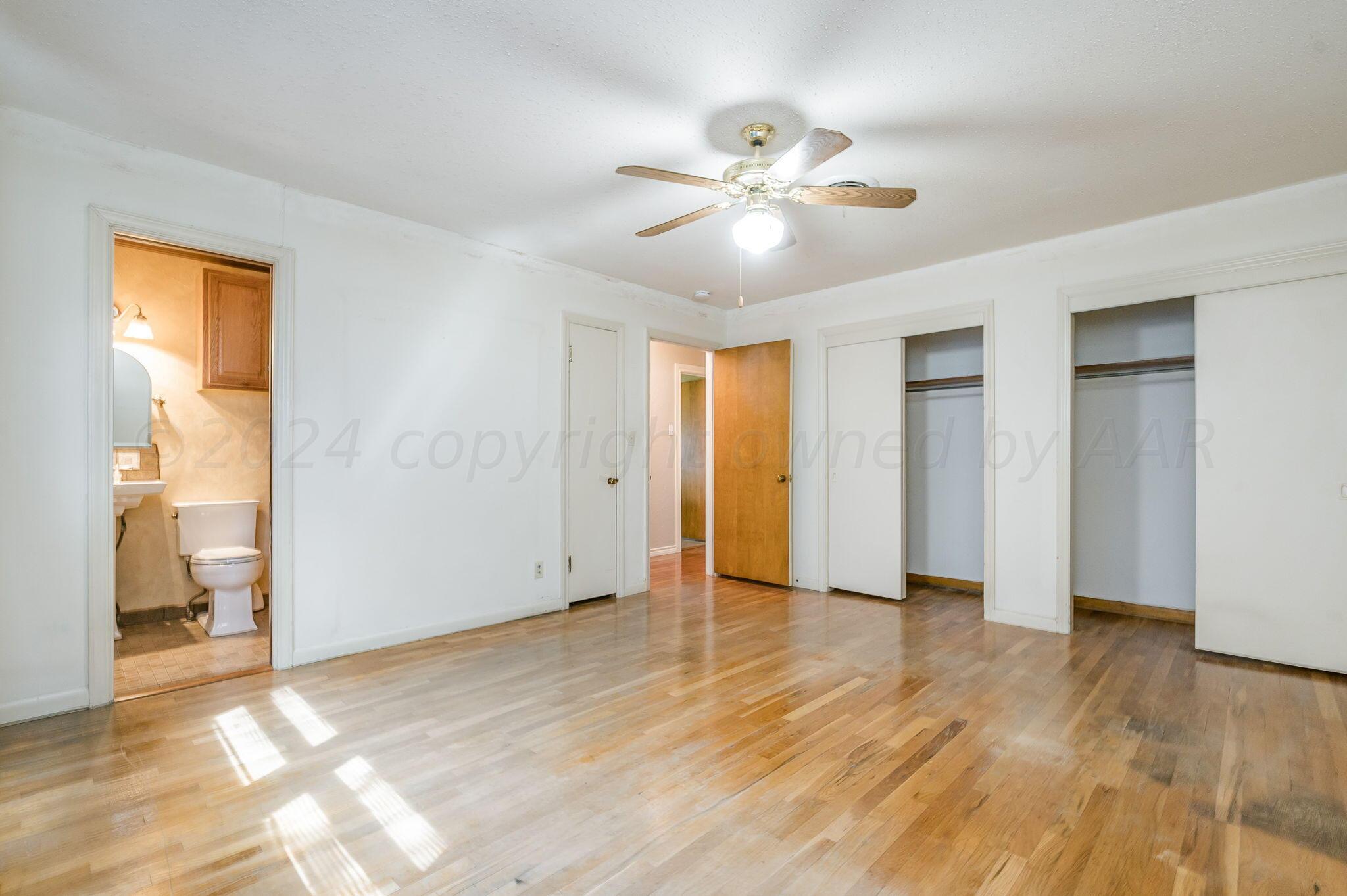 3415 Paramount Boulevard Amarillo, TX 79109 - Photo 20 of 44 a view of an empty room with wooden floor and a window
