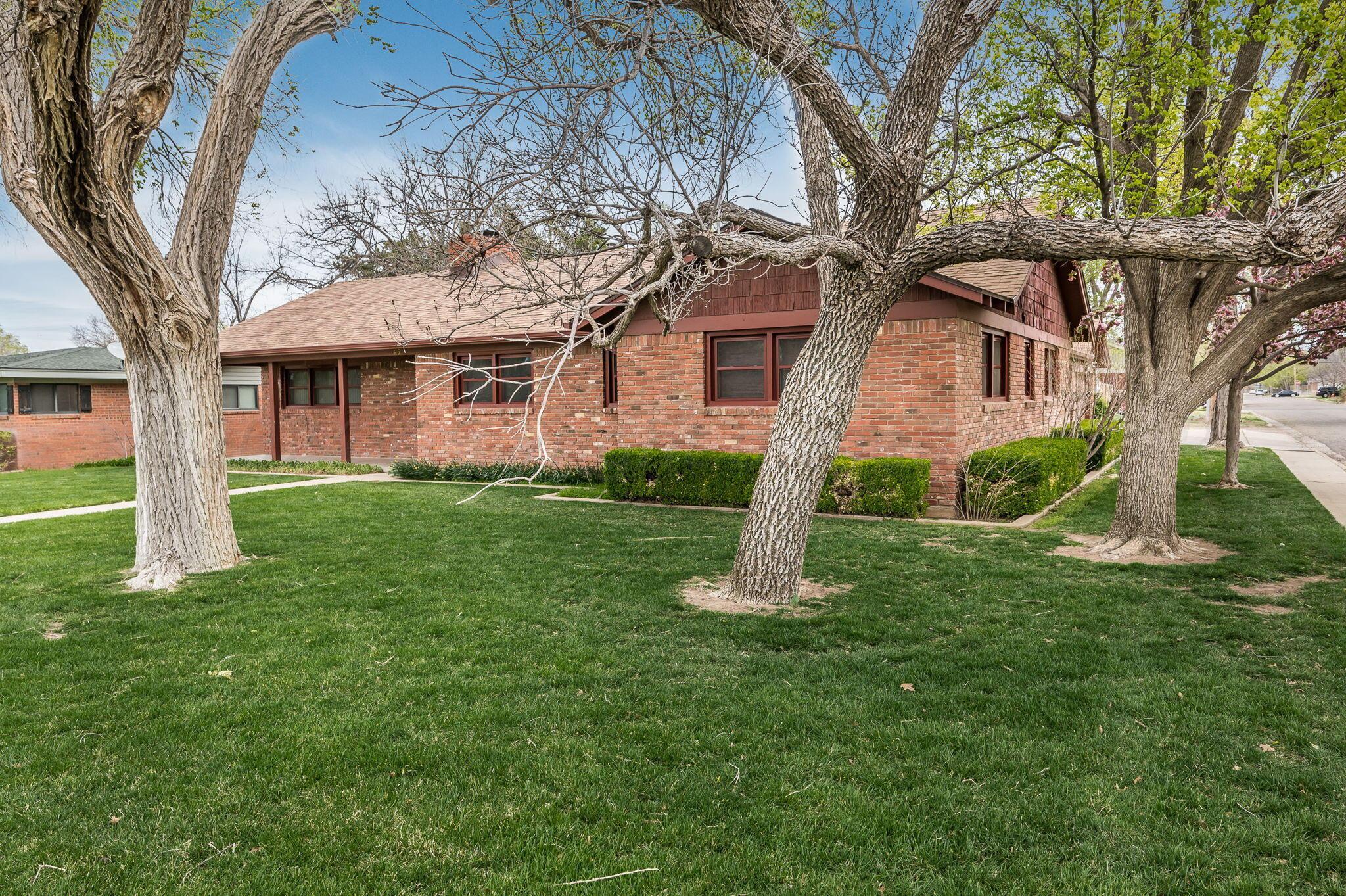 3415 Paramount Boulevard Amarillo, TX 79109 - Photo 2 of 44 a front view of a house with a yard