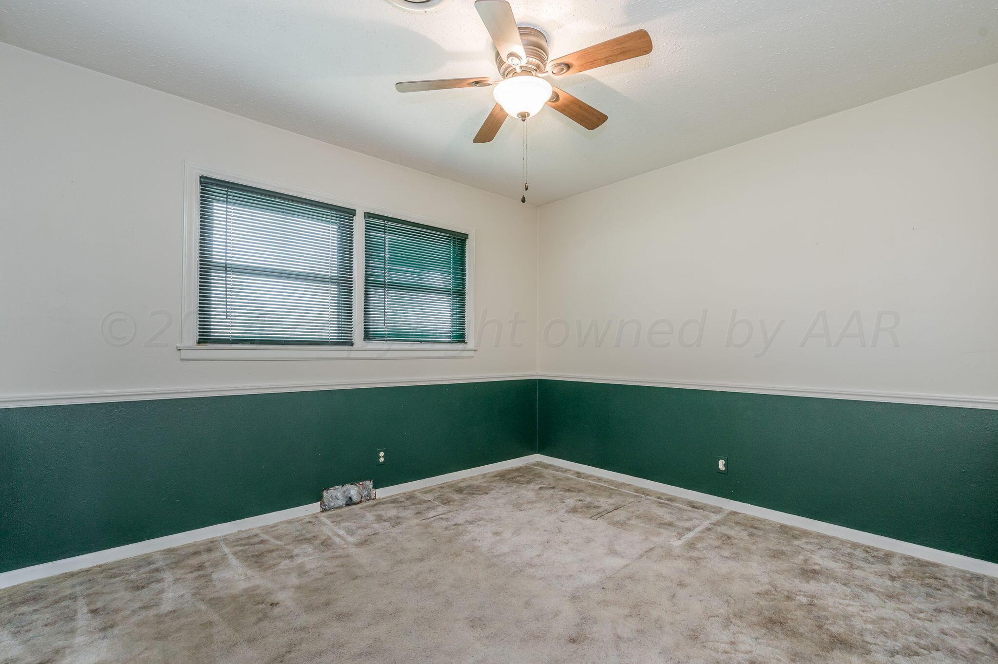 3415 Paramount Boulevard Amarillo, TX 79109 - Photo 24 of 44 an empty room with a window and a fan