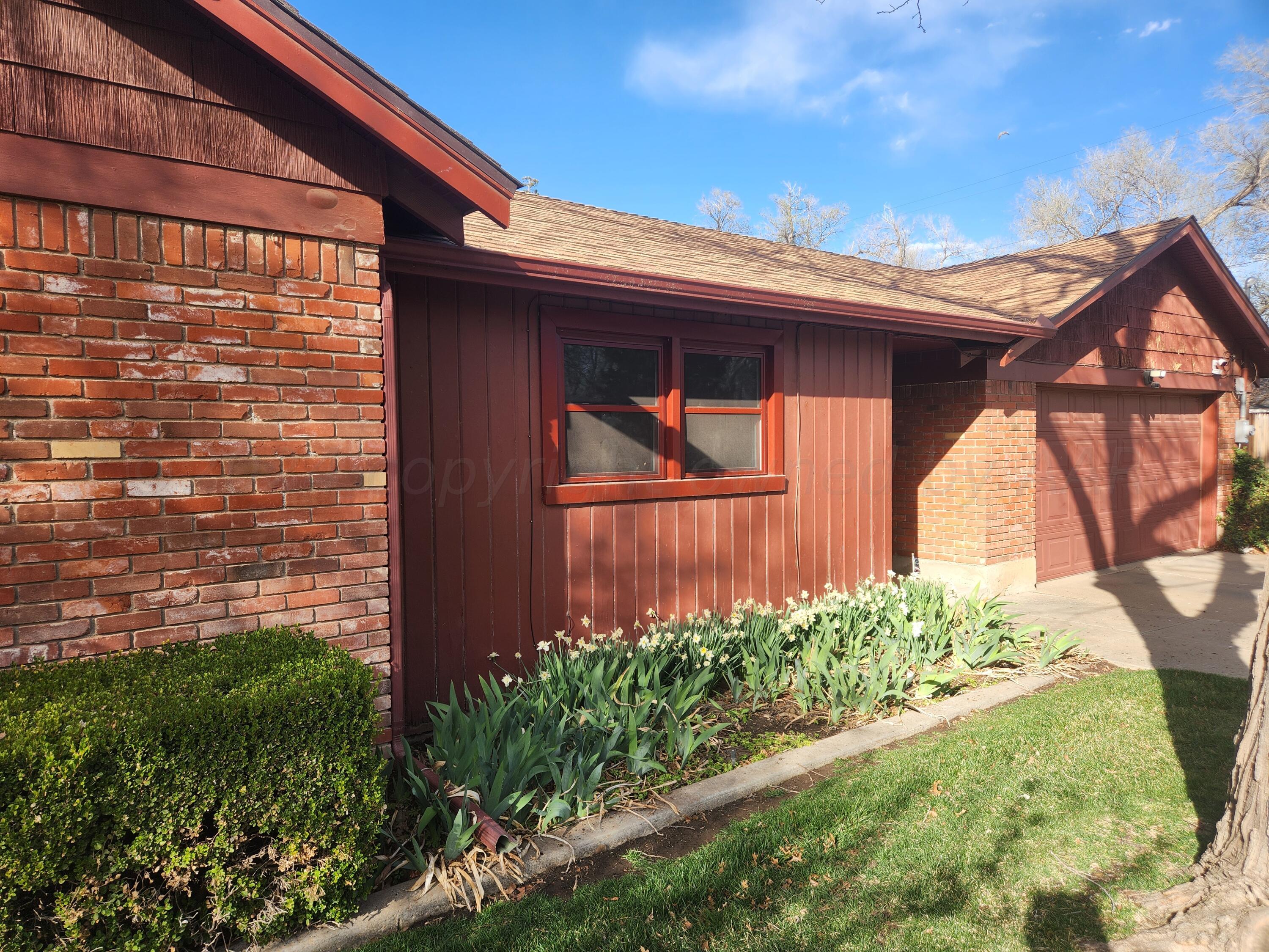 3415 Paramount Boulevard Amarillo, TX 79109 - Photo 3 of 44 a view of a backyard with plants