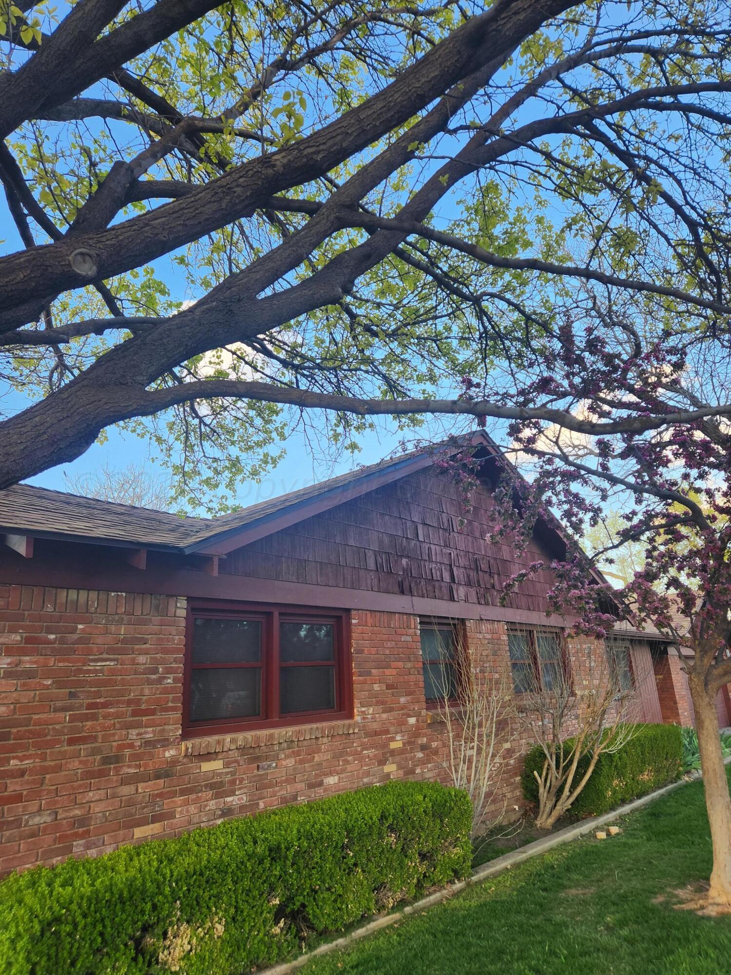 3415 Paramount Boulevard Amarillo, TX 79109 - Photo 5 of 44 a front view of a house with garden