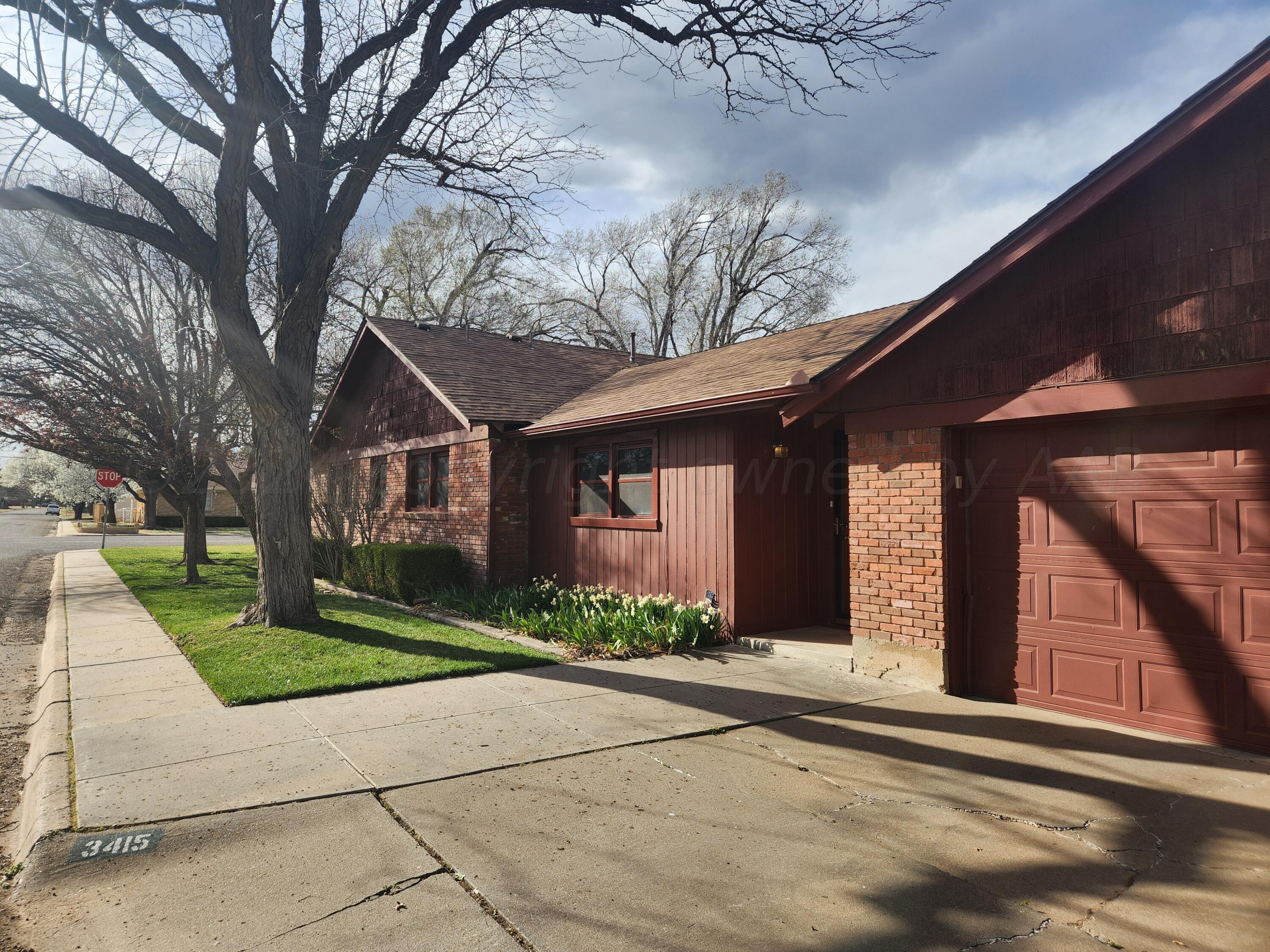 3415 Paramount Boulevard Amarillo, TX 79109 - Photo 6 of 44 a front view of a house with garden