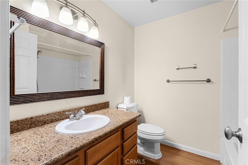 1114 Nord Avenue, Unit 8 Chico, CA 95926 - Photo 18 of 40 a bathroom with a granite countertop sink toilet and mirror