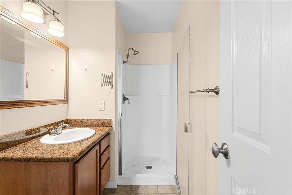 1114 Nord Avenue, Unit 8 Chico, CA 95926 - Photo 27 of 40 a bathroom with a granite countertop sink and a mirror