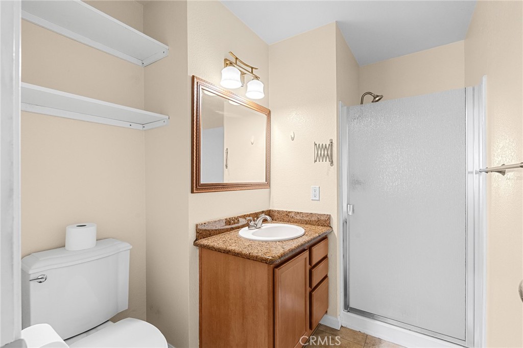 1114 Nord Avenue, Unit 8 Chico, CA 95926 - Photo 28 of 40 a bathroom with a granite countertop sink and a mirror