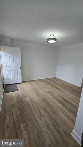 a view of an empty room with a ceiling fan