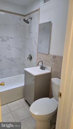 a bathroom with a sink a toilet and bathtub