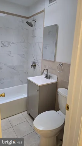 a bathroom with a sink a toilet and bathtub