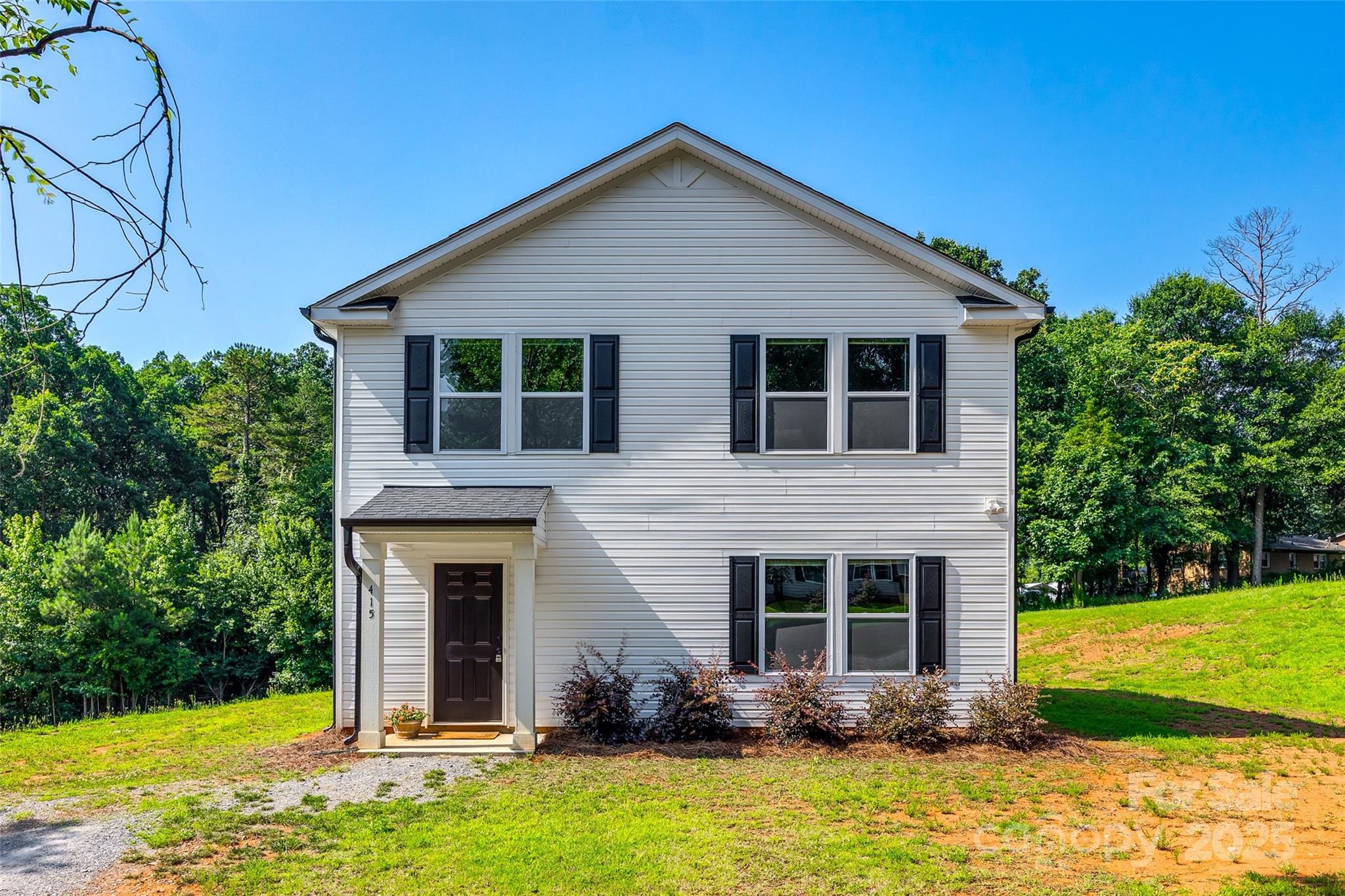 a front view of a house with yard