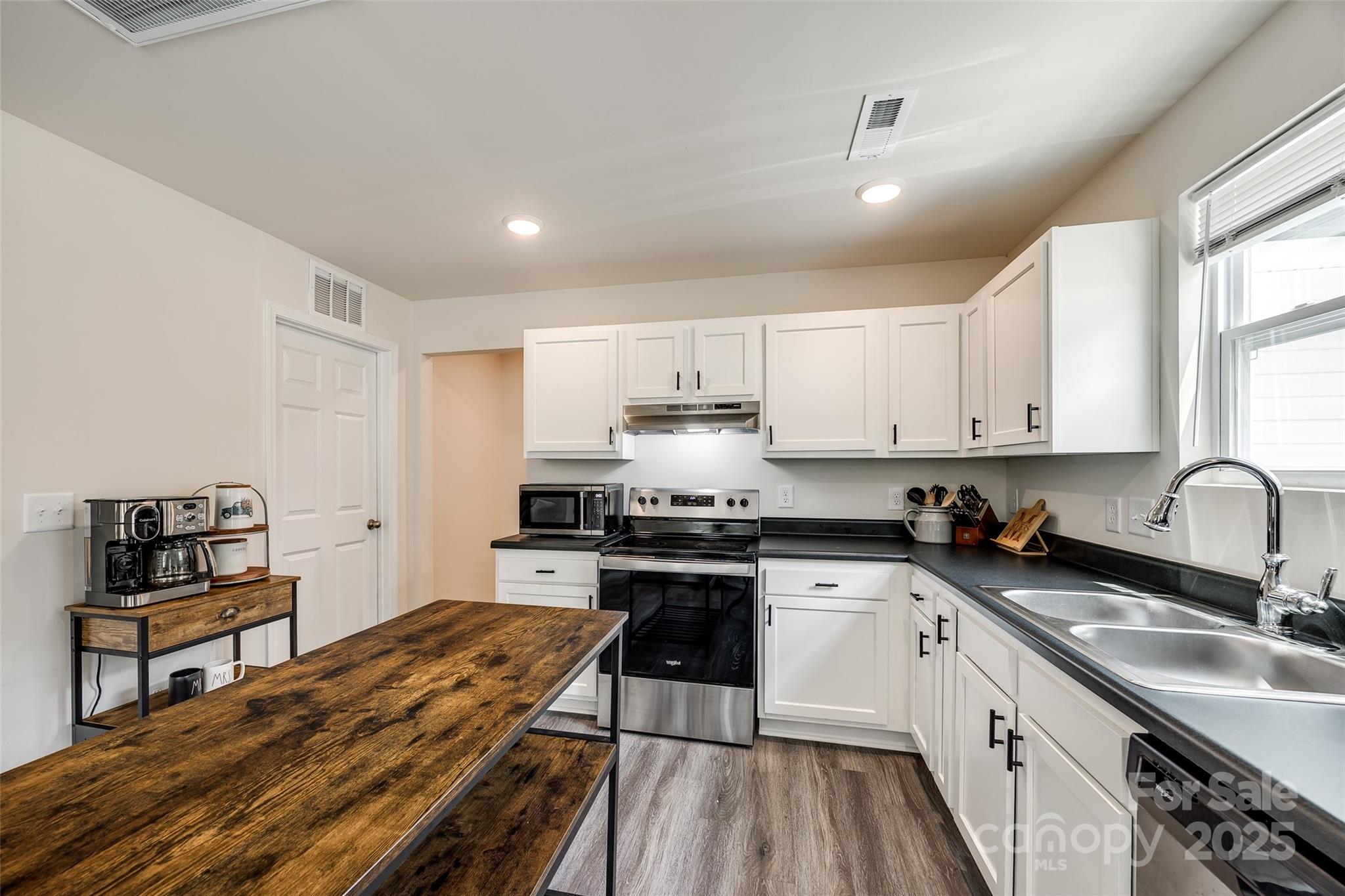 415 Kickapoo Avenue Gastonia, NC 28056 - Photo 11 of 24 a kitchen with stainless steel appliances granite countertop a stove sink and cabinets