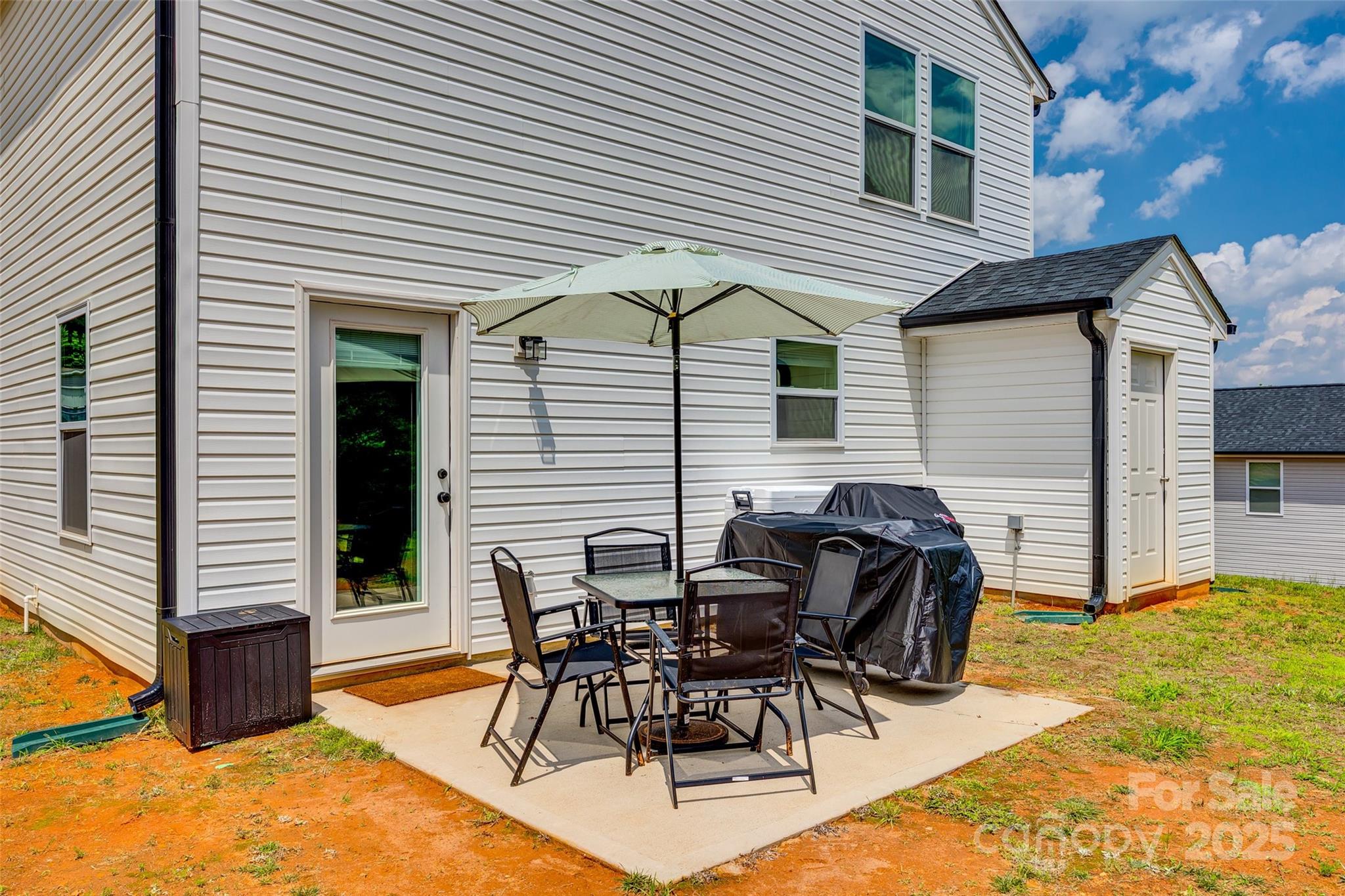 415 Kickapoo Avenue Gastonia, NC 28056 - Photo 21 of 24 a view of a patio with table and chairs and wooden fence