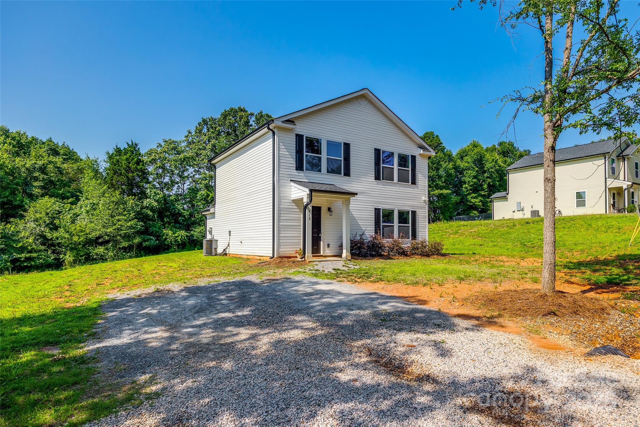 415 Kickapoo Avenue Gastonia, NC 28056 - Photo 3 of 24 a front view of a house with a yard and garage