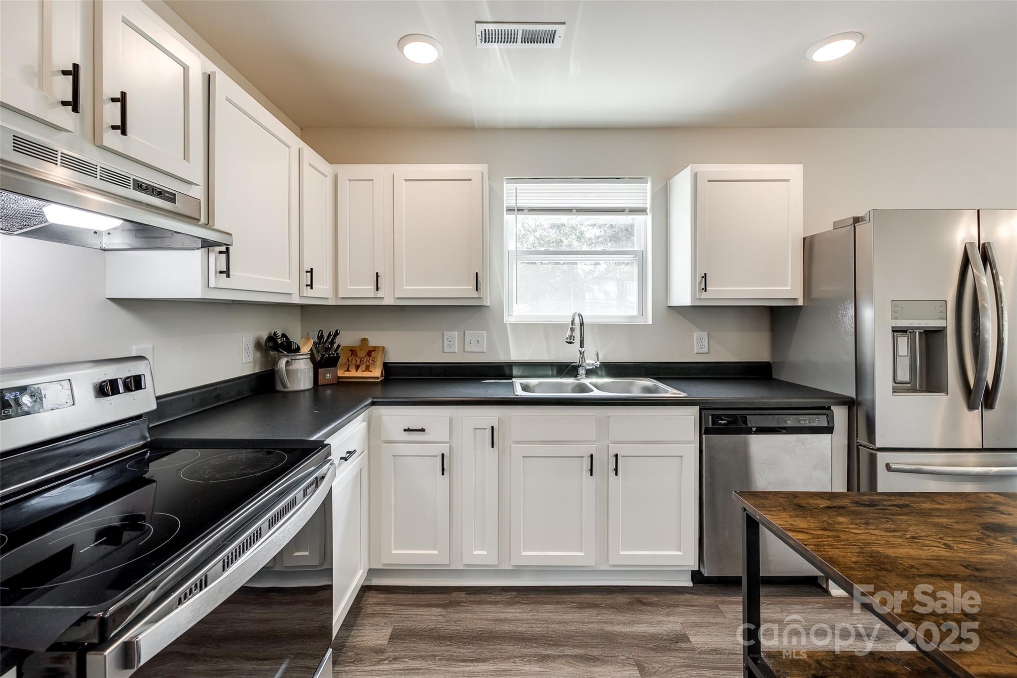 415 Kickapoo Avenue Gastonia, NC 28056 - Photo 10 of 24 a kitchen with granite countertop a stove a sink and a refrigerator
