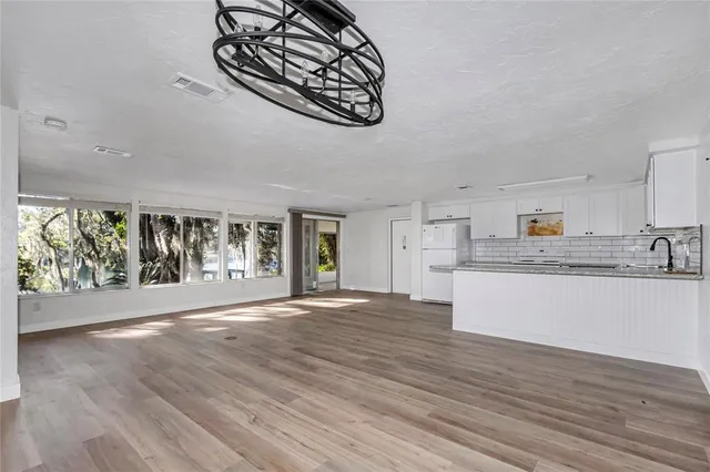 a view of kitchen with granite countertop a stove and a wooden floors