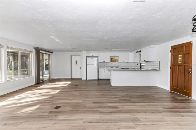 a view of kitchen with wooden floor and windows