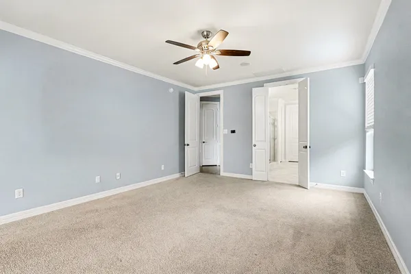 a view of an empty room with a ceiling fan