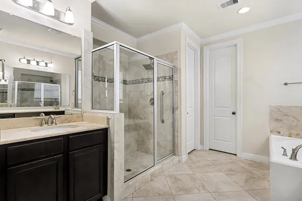 a bathroom with a shower sink and mirror