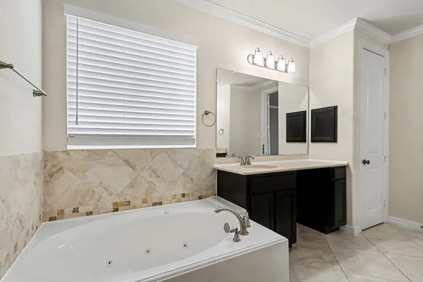 a bathroom with a bathtub and a sink