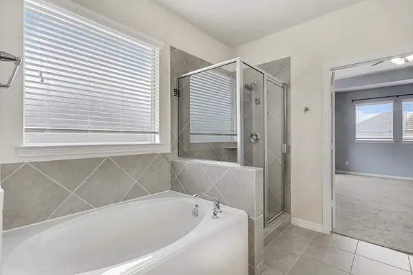a bathroom with a bathtub and a shower