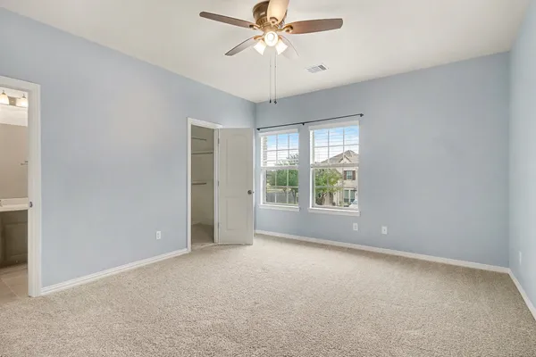 a view of a livingroom with a ceiling fan and window