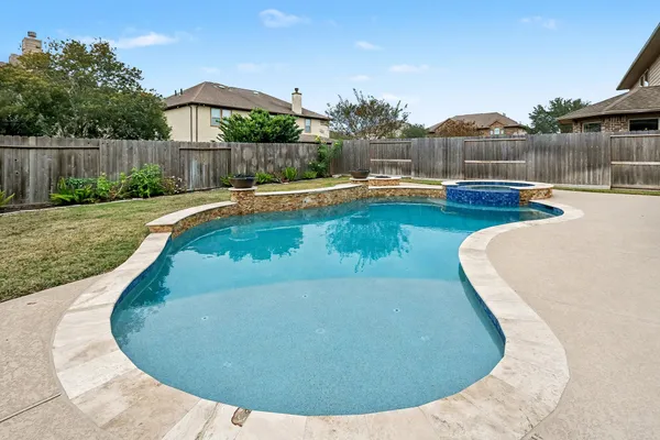 a view of a swimming pool with a patio