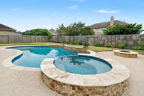 a view of a swimming pool with a yard
