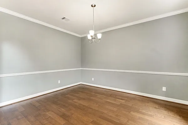a view of a room with an empty space and a ceiling fan