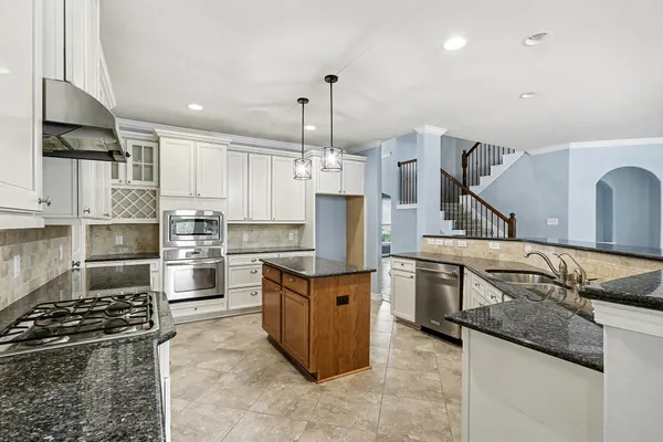 a kitchen with a stove and a refrigerator