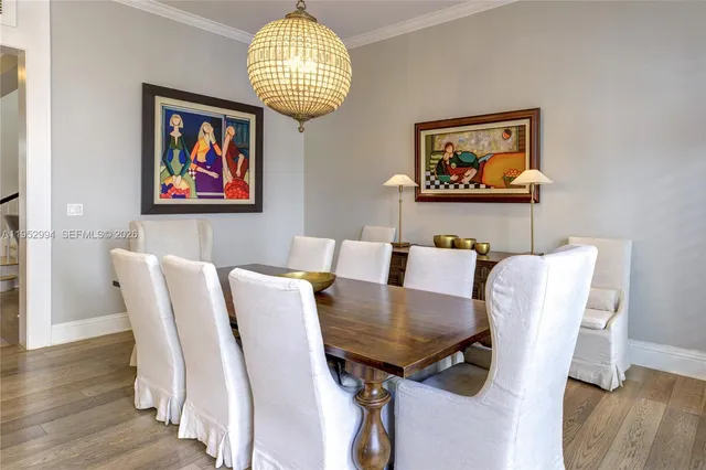 a view of a dining room with furniture wooden floor and chandelier