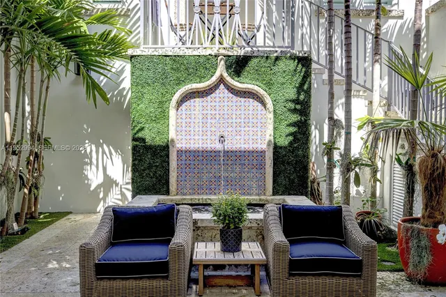 a view of a patio with a table and chairs