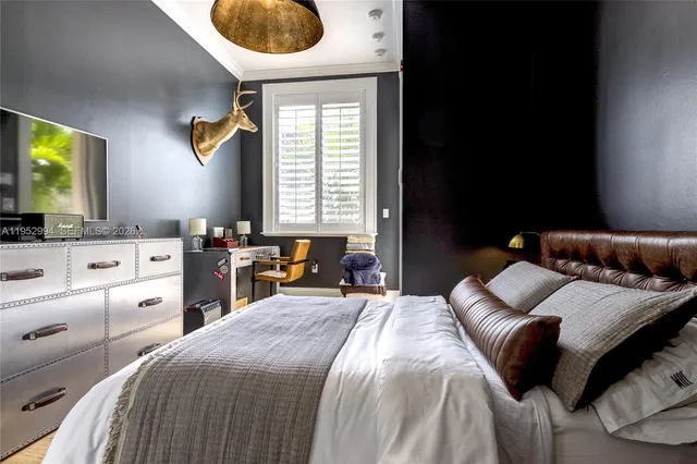 a bedroom with a bed and a television