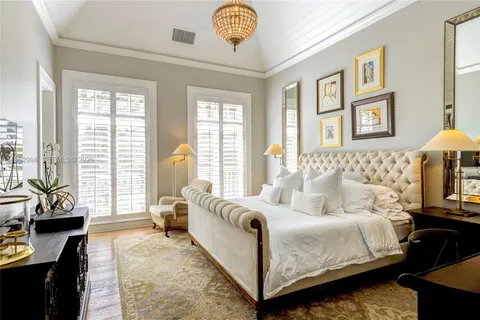 a spacious bedroom with a bed a couch and a window