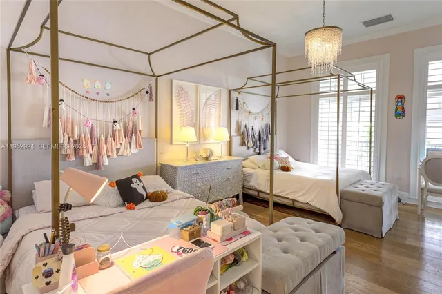 a bedroom with furniture and a chandelier