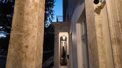 a view of a hallway with wooden door