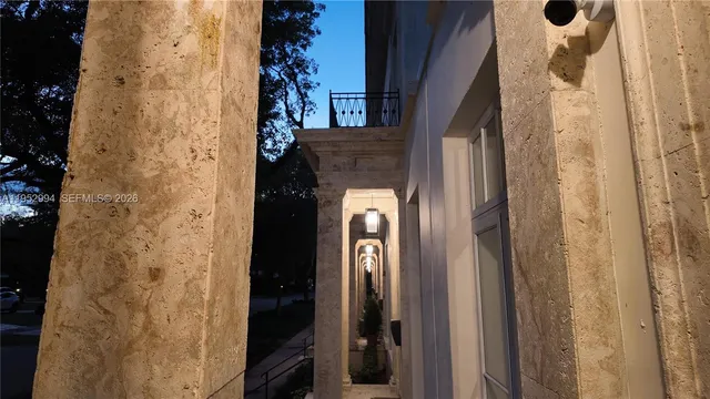 a view of a hallway with wooden door