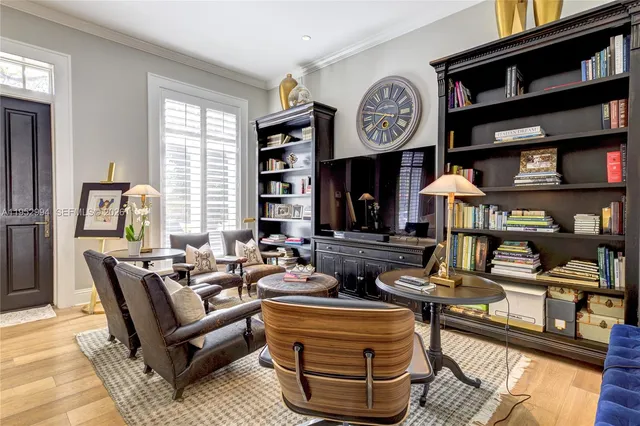 a living room with furniture and a clock