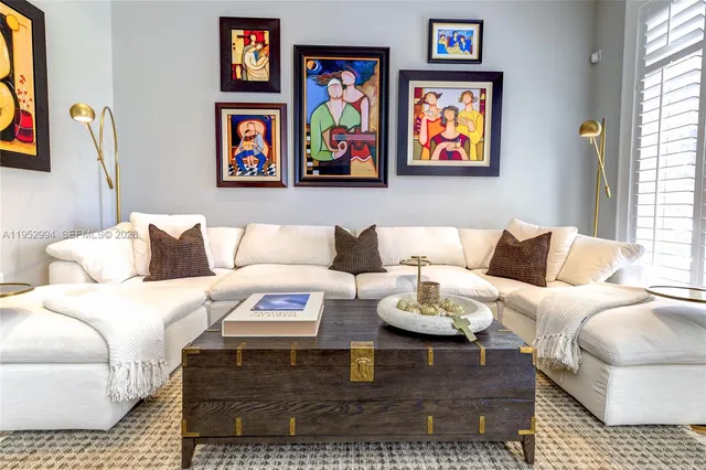 a living room with furniture and painting on the wall