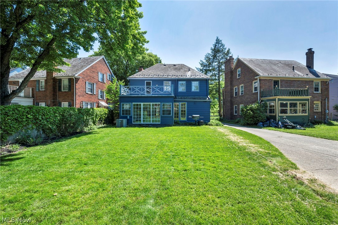 3543 Lytle Road Shaker Heights, OH 44122 - Photo 49 of 49 Spacious lawn extending to the rear of the blue residence, featuring a second-story balcony with white railings and ground-level sliding glass doors