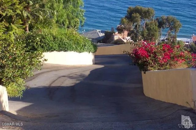 a view of a balcony with wooden floor and fence