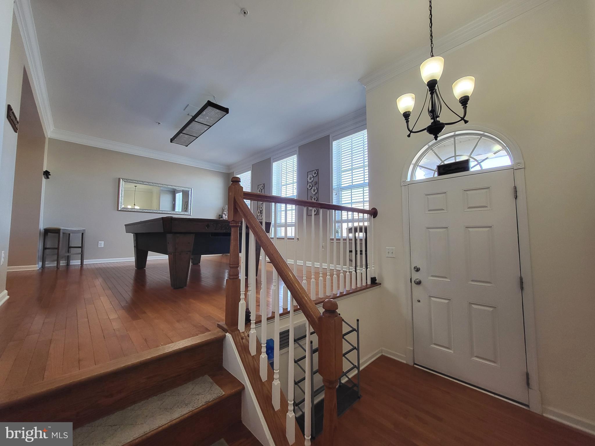 11011 Buggy Path Upper Marlboro, MD 20772 - Photo 2 of 82 a dining room with wooden floor a chandelier a wooden table and chairs