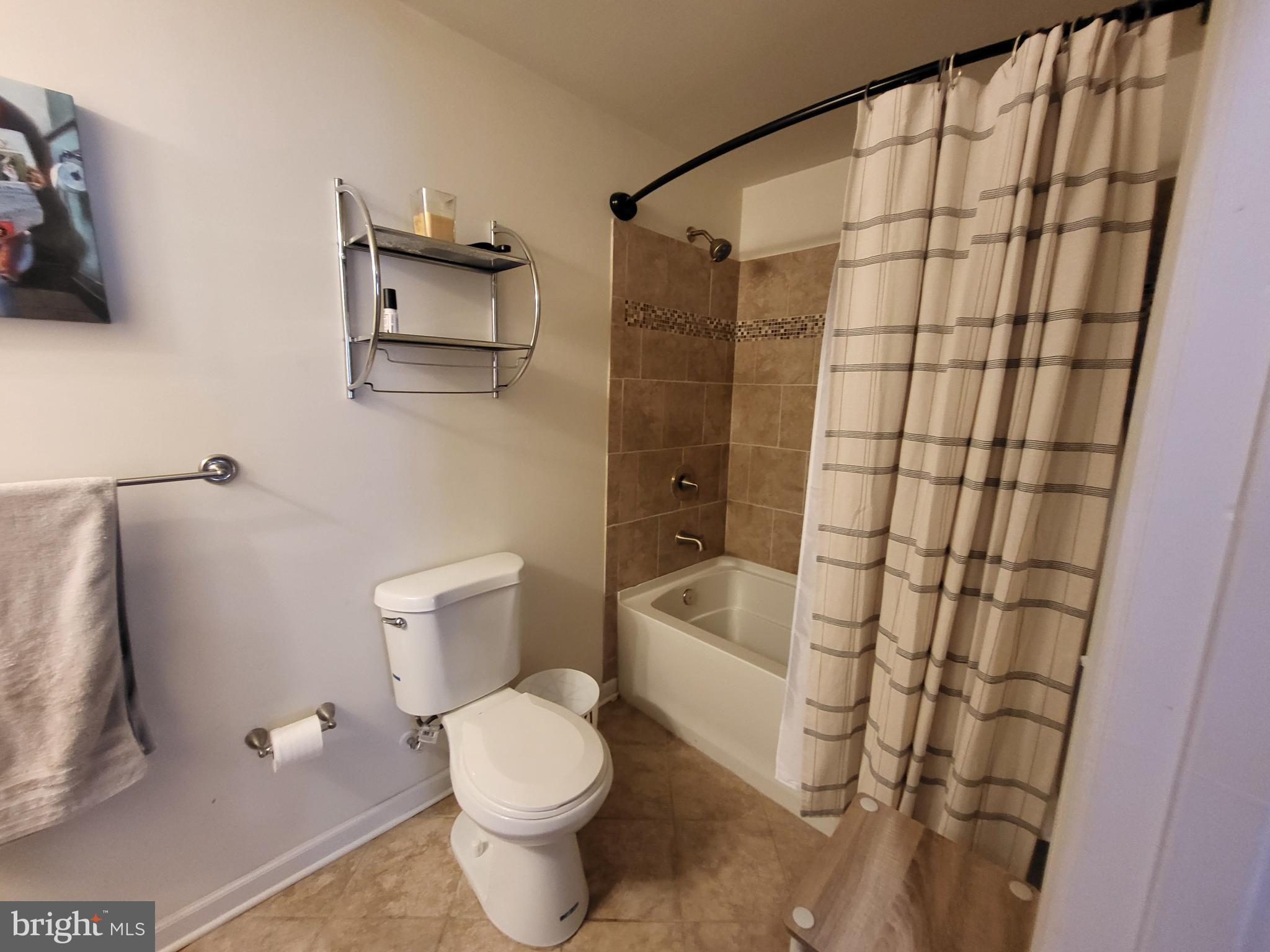 11011 Buggy Path Upper Marlboro, MD 20772 - Photo 62 of 82 a bathroom with a toilet and a shower curtain