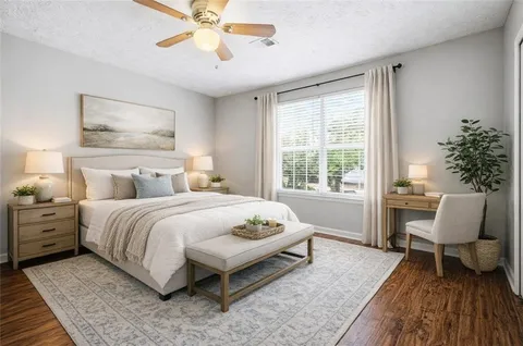 a bedroom with a bed and a chair