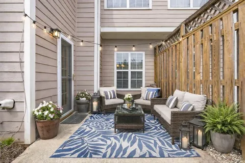 a balcony with furniture and a potted plant