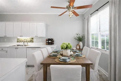 a kitchen with a table and chairs in it