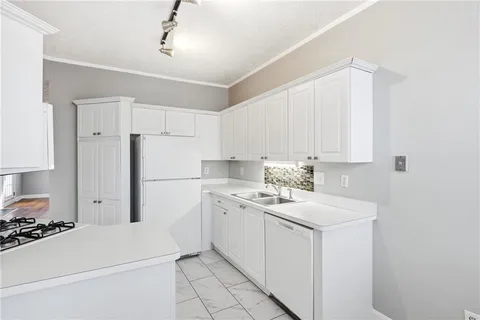 a kitchen with a white stove top oven and white cabinets