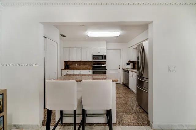 a bathroom with a granite countertop sink mirror and a shower