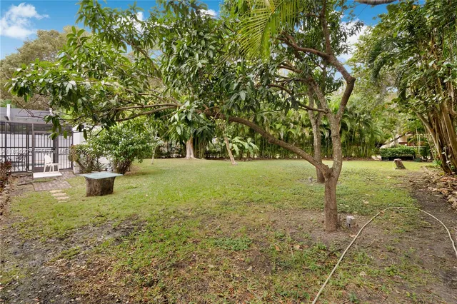 an aerial view of a house with a yard and garden